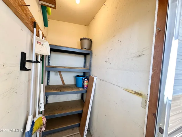 a view of a hallway with a door and the stairs