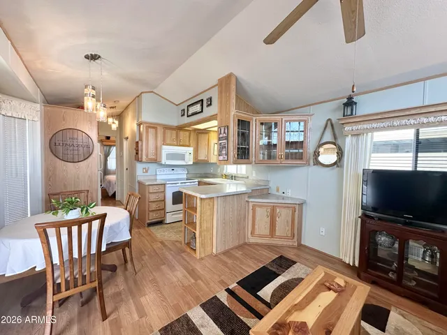 a living room with kitchen island furniture and a flat screen tv