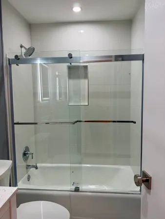 a bathroom with a bathtub and a shower