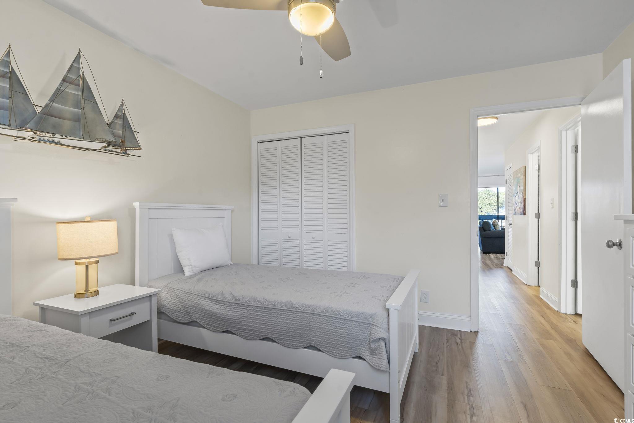 310 3rd Avenue North, Unit A2 Surfside Beach, SC 29575 - Photo 17 of 40 Bedroom with a closet, wood finished floors, and ceiling fan