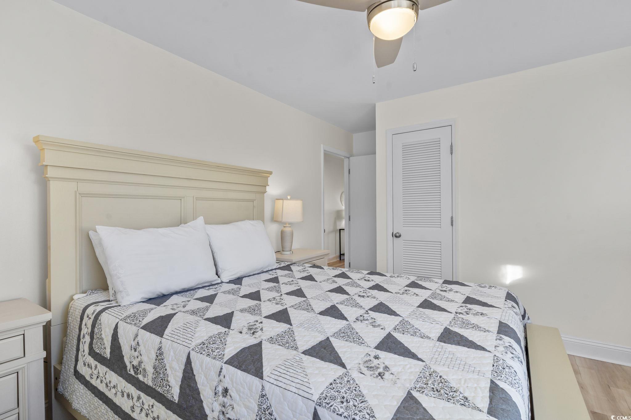 310 3rd Avenue North, Unit A2 Surfside Beach, SC 29575 - Photo 19 of 40 Bedroom featuring a closet, ceiling fan, and light wood-style floors