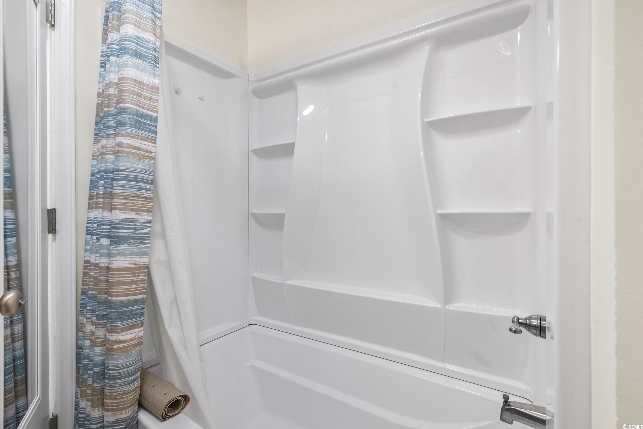 310 3rd Avenue North, Unit A2 Surfside Beach, SC 29575 - Photo 22 of 40 Full bath with shower / bath combo with shower curtain