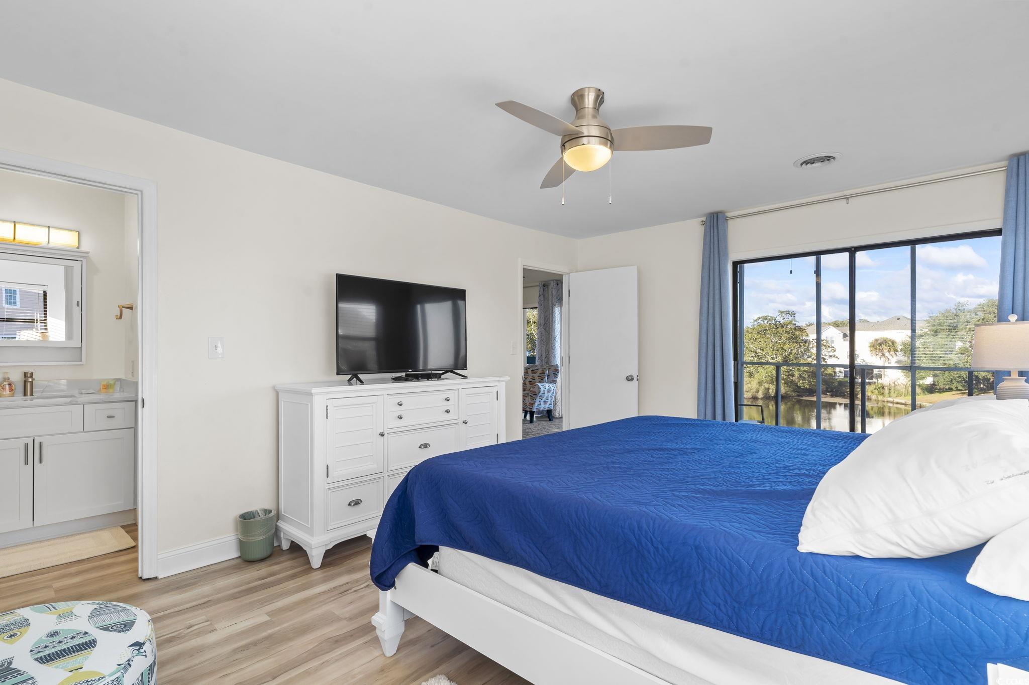 310 3rd Avenue North, Unit A2 Surfside Beach, SC 29575 - Photo 24 of 40 Bedroom with light wood-style flooring, access to exterior, a ceiling fan, and ensuite bath
