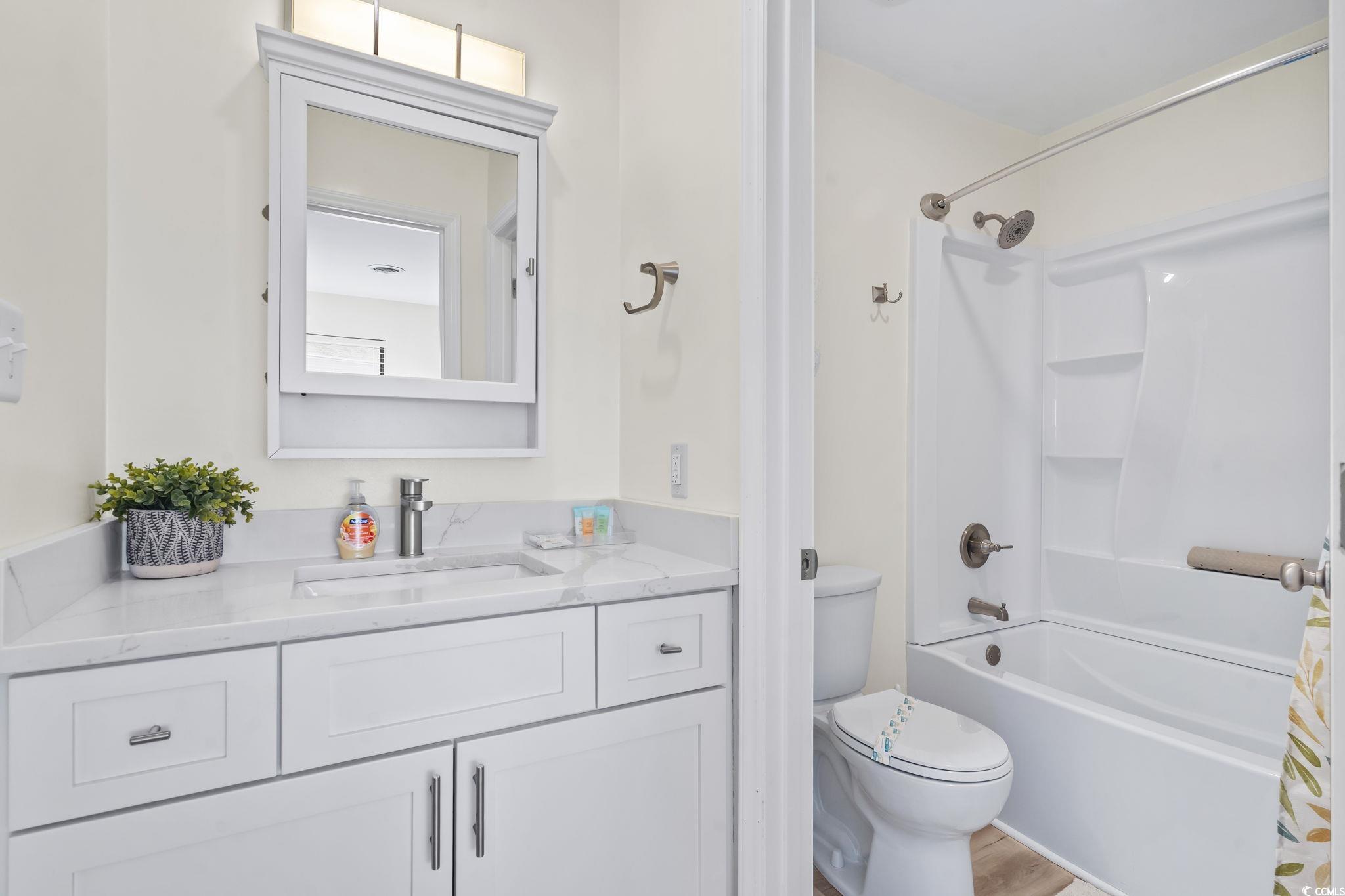 310 3rd Avenue North, Unit A2 Surfside Beach, SC 29575 - Photo 25 of 40 Bathroom with vanity and shower / bath combination