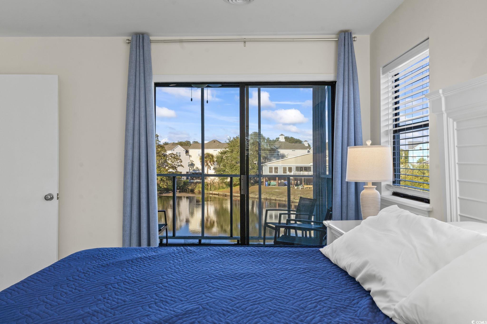 310 3rd Avenue North, Unit A2 Surfside Beach, SC 29575 - Photo 28 of 40 Bedroom with a water view and access to exterior