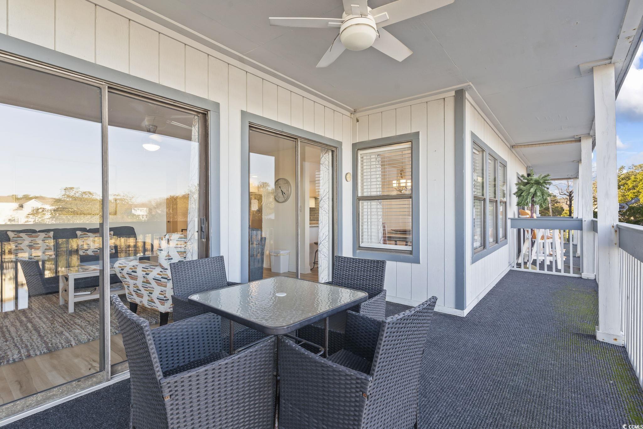 310 3rd Avenue North, Unit A2 Surfside Beach, SC 29575 - Photo 31 of 40 Deck with a ceiling fan and outdoor dining space