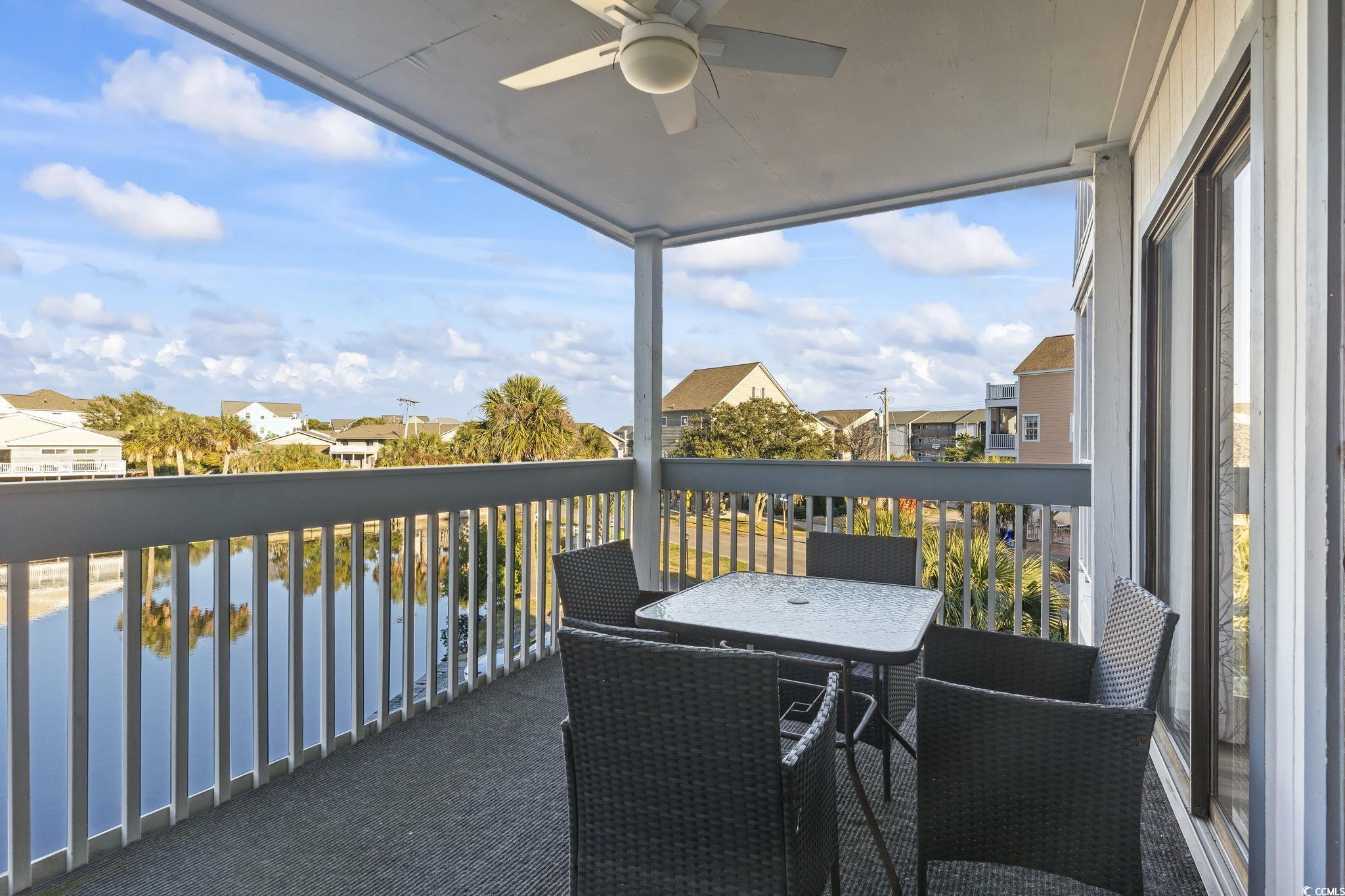310 3rd Avenue North, Unit A2 Surfside Beach, SC 29575 - Photo 32 of 40 Balcony featuring a ceiling fan, a water view, and a residential view