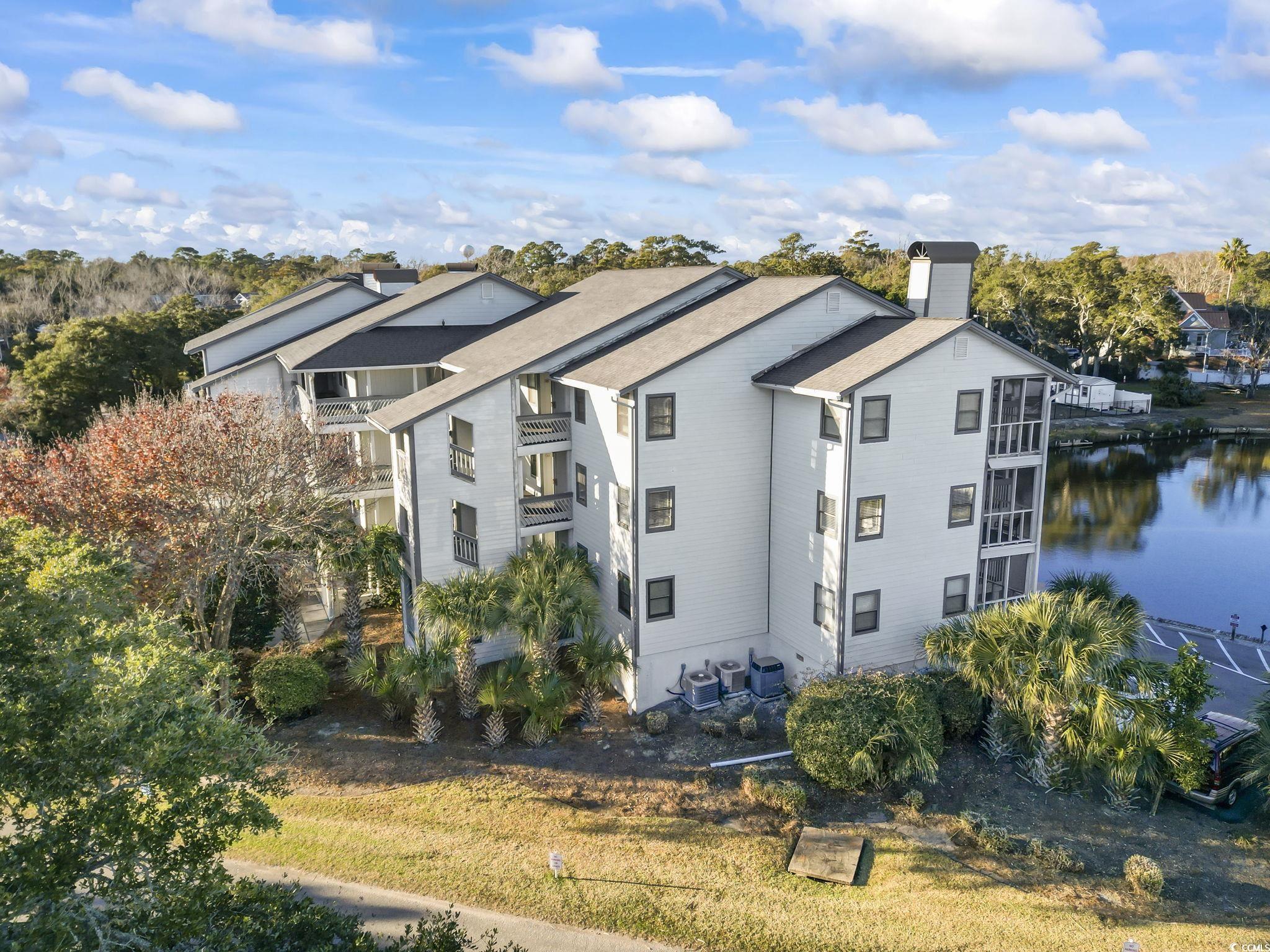 310 3rd Avenue North, Unit A2 Surfside Beach, SC 29575 - Photo 37 of 40 View of side of home with a chimney and a water view
