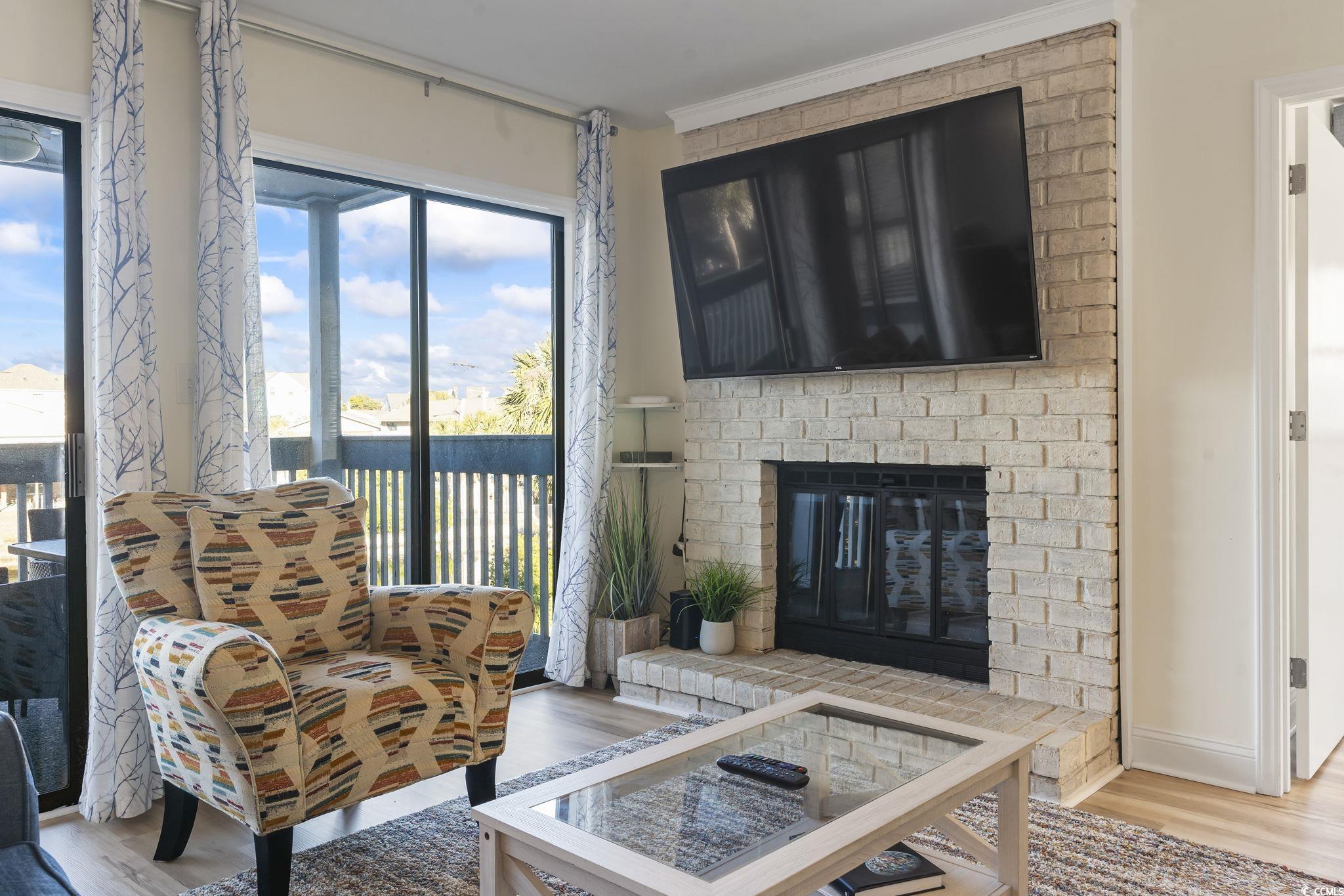 310 3rd Avenue North, Unit A2 Surfside Beach, SC 29575 - Photo 6 of 40 Living room with wood finished floors and a fireplace