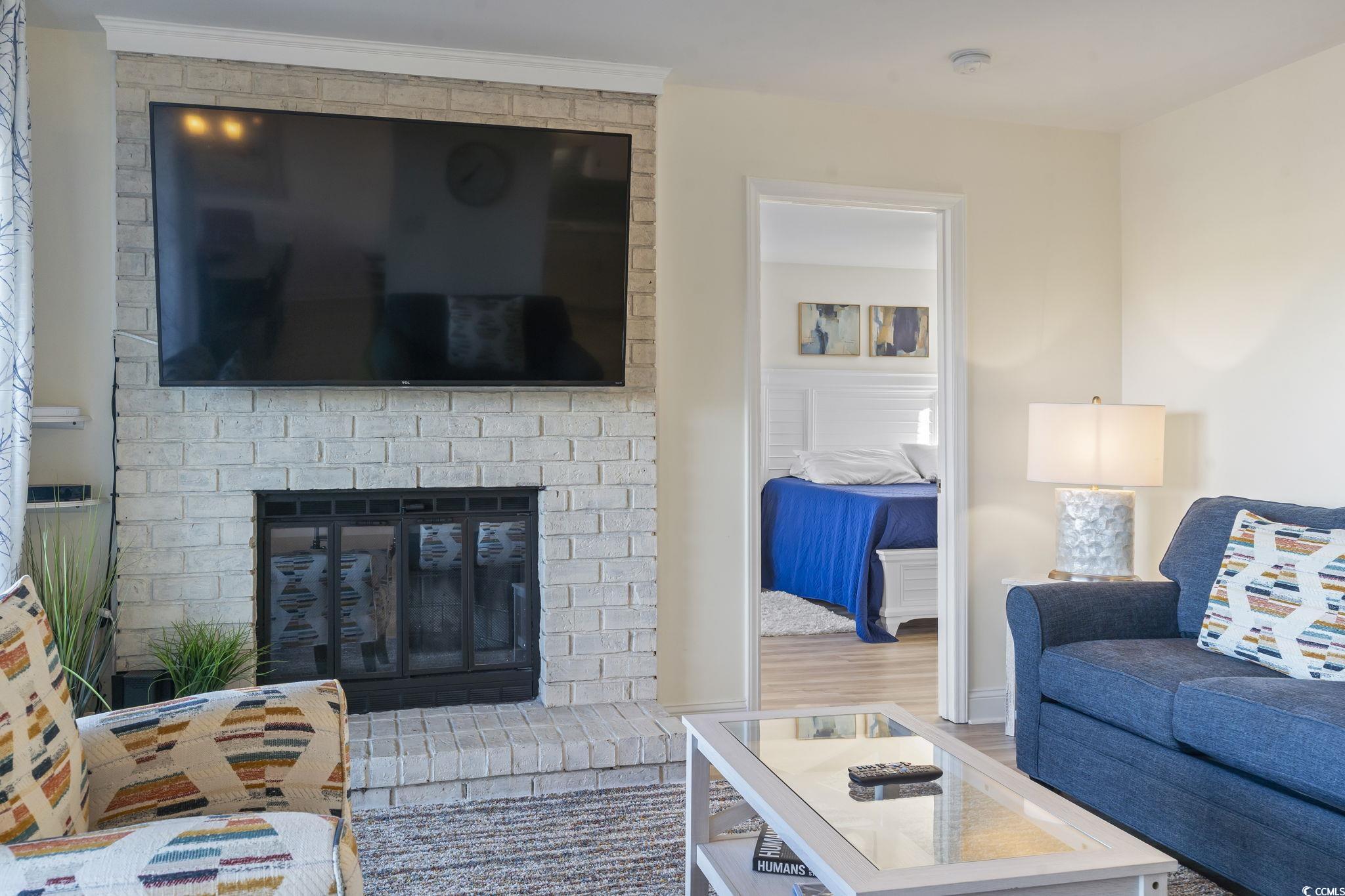 310 3rd Avenue North, Unit A2 Surfside Beach, SC 29575 - Photo 7 of 40 Living room featuring wood finished floors and a fireplace
