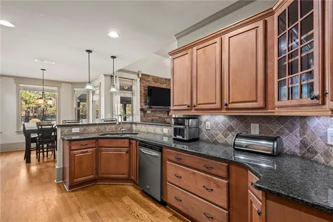 a kitchen with stainless steel appliances granite countertop a stove a sink and a microwave