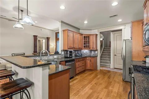 a kitchen with stainless steel appliances granite countertop a sink stove and refrigerator