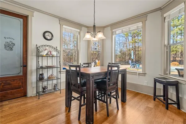 a view of a dining room with furniture window and wooden floor