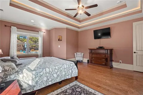 a spacious bedroom with a bed and a chandelier