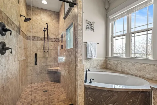 a view of walk in closet with clothes