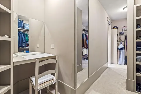 a bedroom with a bed a chair and a window