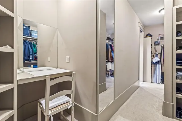 a bedroom with a bed a chair and a window