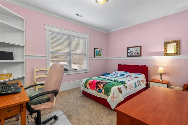a bedroom that has a bed and a table in it