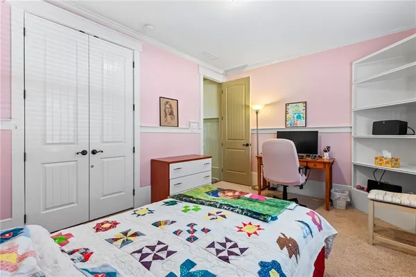 a bedroom with a bed and a dresser in it