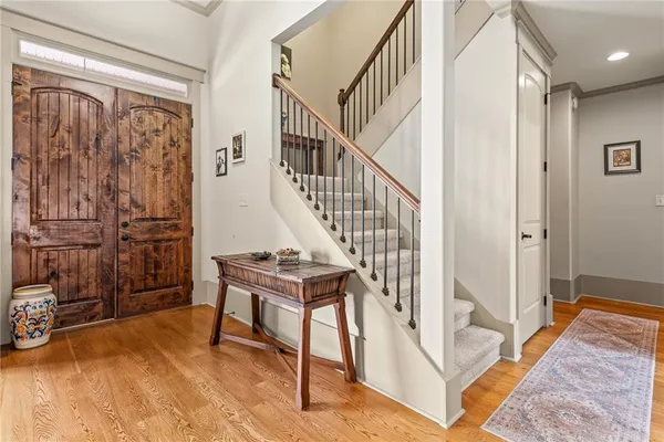 a view of entryway with wooden floor and windows