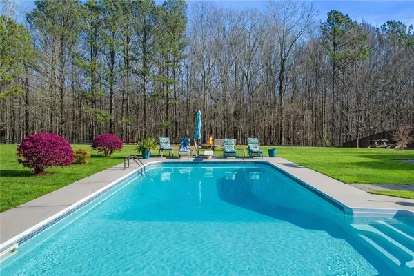 a backyard of a house with table and chairs