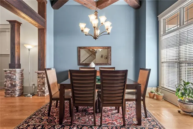a view of a dining room with furniture and chandelier