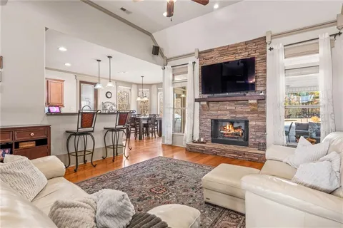 a living room with furniture fireplace and flat screen tv