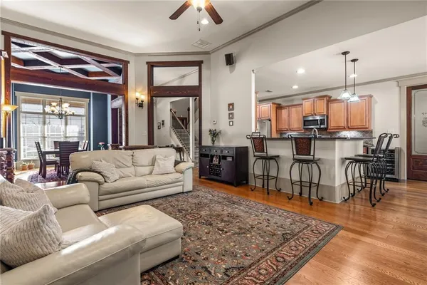 a living room with furniture and kitchen view