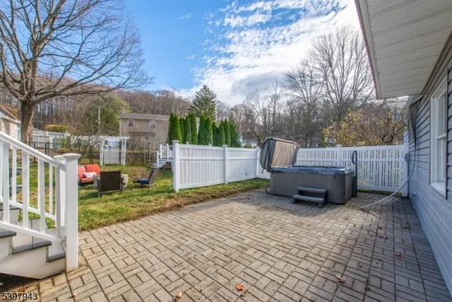 a backyard of a house with table and chairs