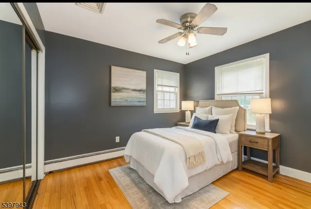 a bedroom with a bed and a ceiling fan