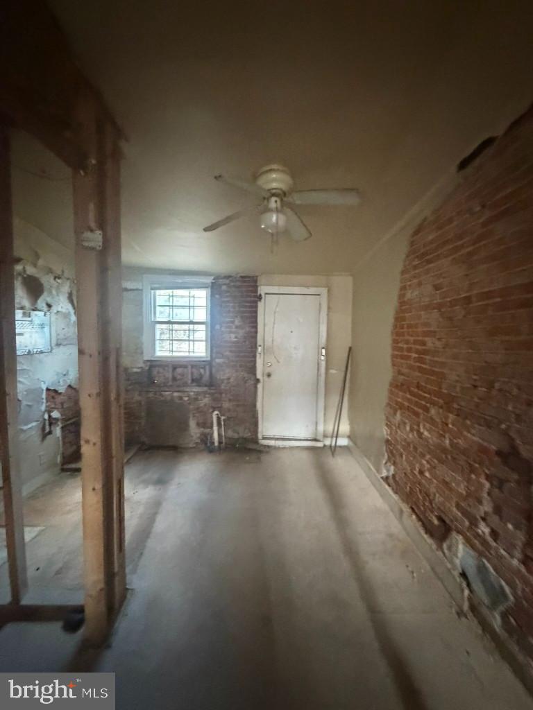 1610 Lemmon Street Baltimore, MD 21223 - Photo 7 of 22 wooden floor in an empty room with a window