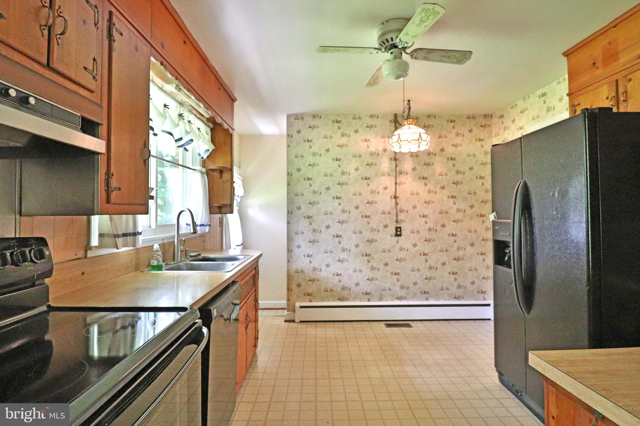 6708 Cherry Hill Road Baldwin, MD 21013 - Photo 11 of 44 a kitchen with a refrigerator a sink and a stove