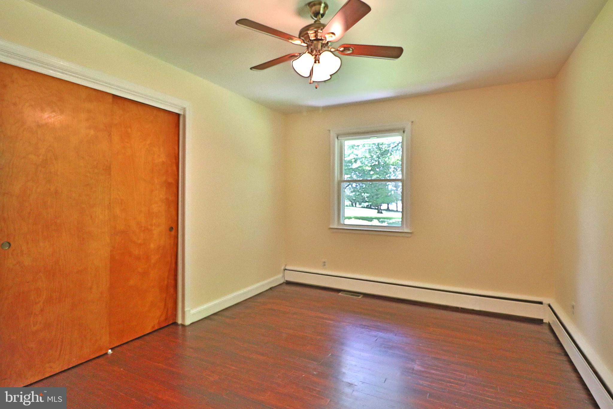 6708 Cherry Hill Road Baldwin, MD 21013 - Photo 13 of 44 a view of an empty room with window and wooden floor
