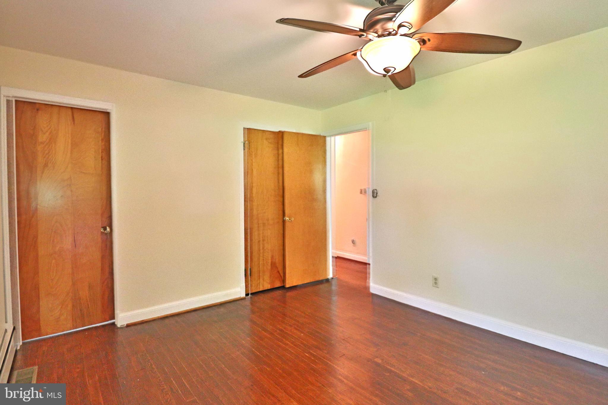 6708 Cherry Hill Road Baldwin, MD 21013 - Photo 17 of 44 an empty room with wooden floor fan and windows