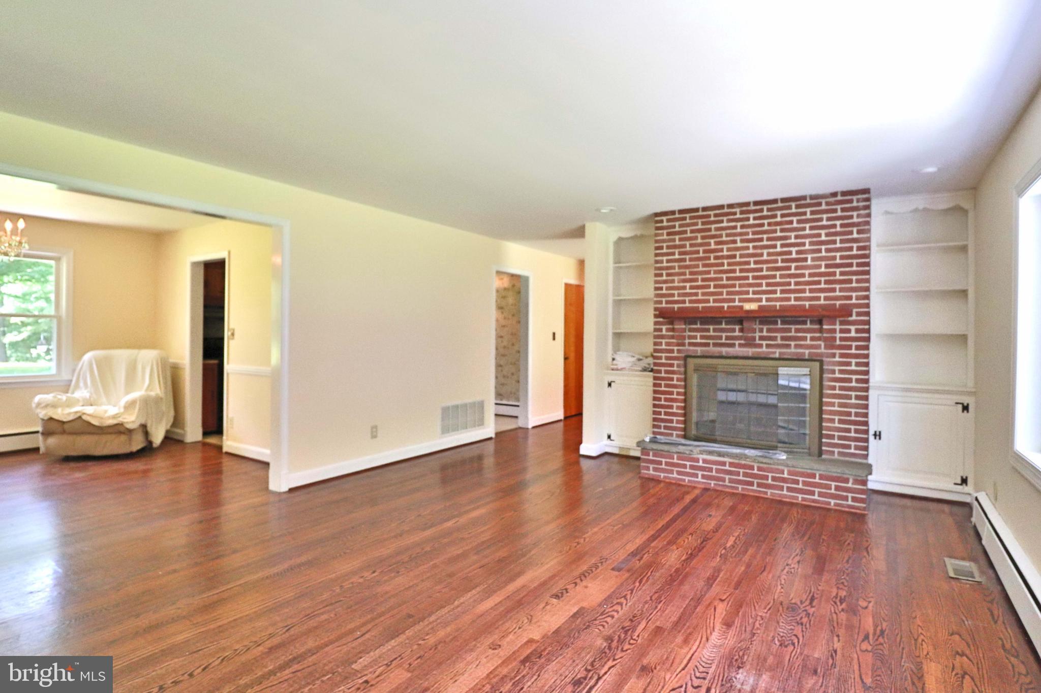 6708 Cherry Hill Road Baldwin, MD 21013 - Photo 3 of 44 a view of livingroom with hardwood floor and a fireplace