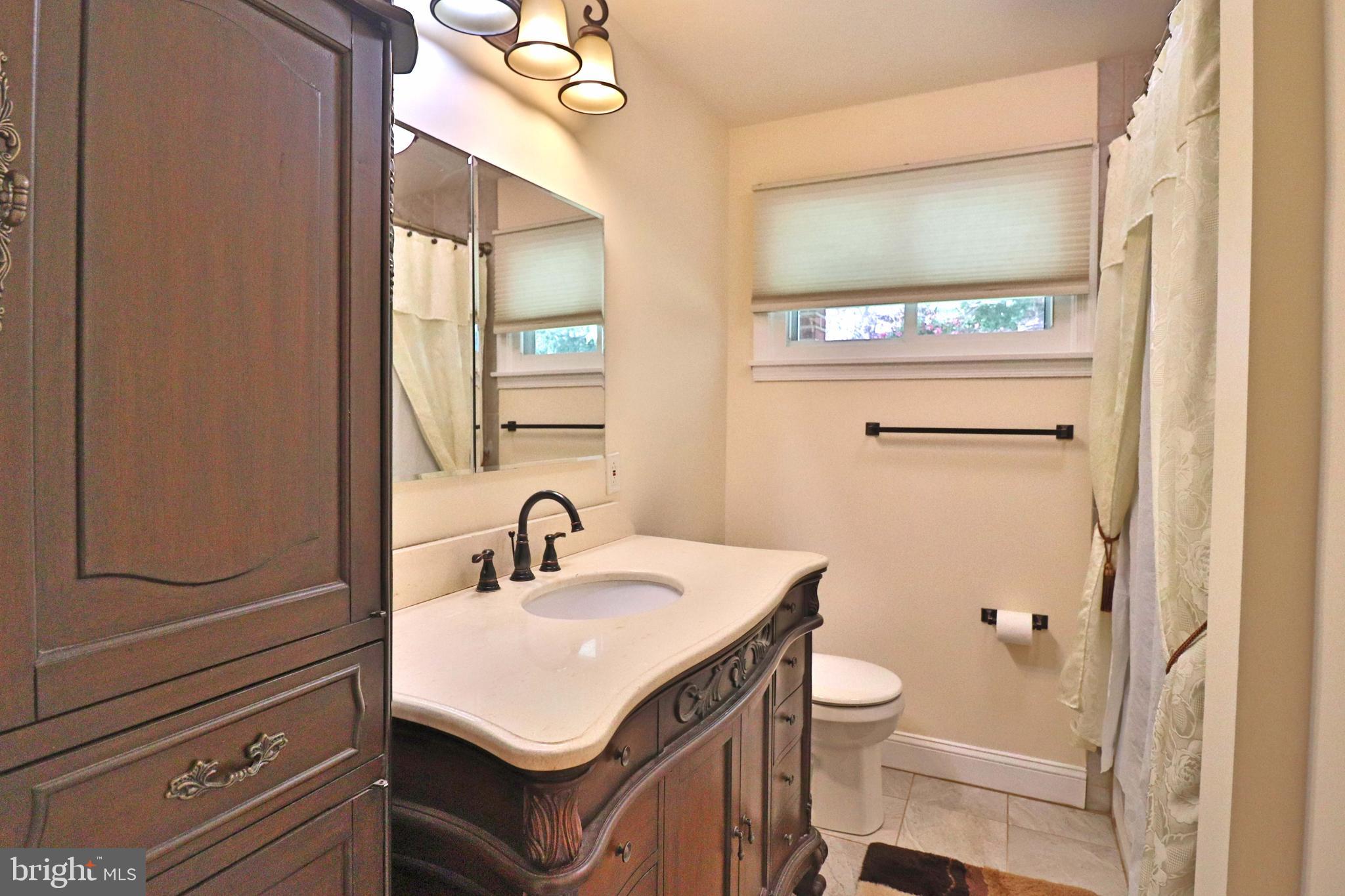 6708 Cherry Hill Road Baldwin, MD 21013 - Photo 22 of 44 a bathroom with a sink toilet and mirror