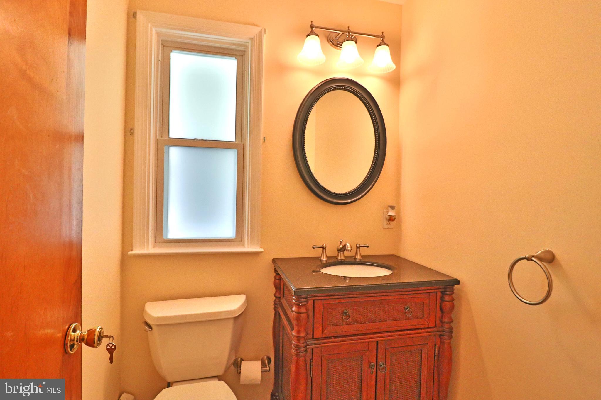 6708 Cherry Hill Road Baldwin, MD 21013 - Photo 24 of 44 a bathroom with a toilet a sink and a mirror