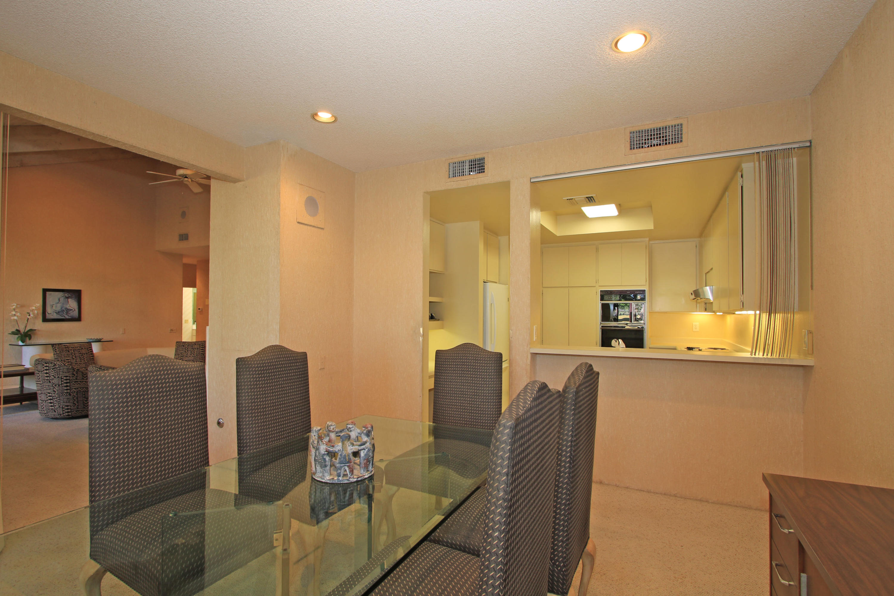 924 Inverness Drive Rancho Mirage, CA 92270 - Photo 14 of 44 a large living room with stainless steel appliances kitchen island granite countertop furniture and a large window