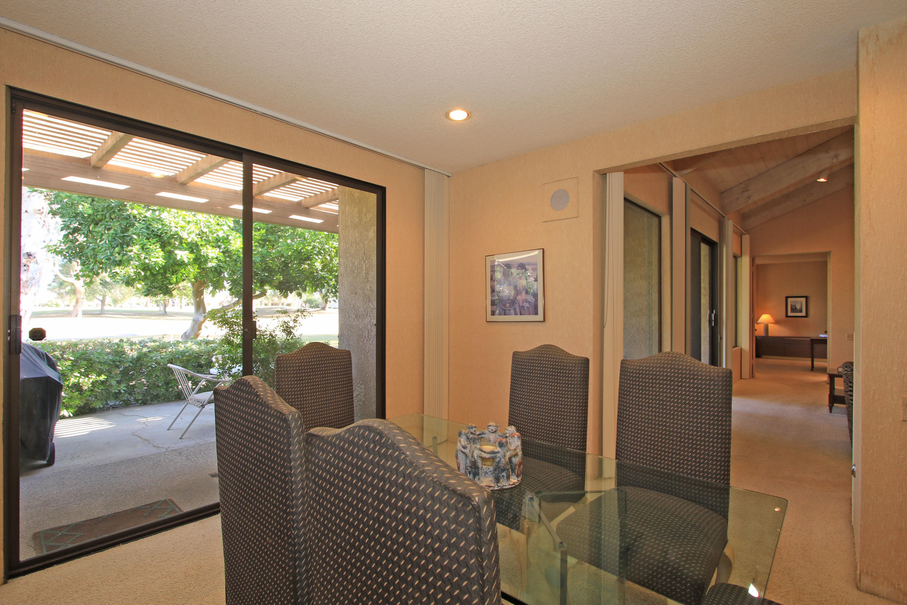 924 Inverness Drive Rancho Mirage, CA 92270 - Photo 16 of 44 a living room with furniture and a floor to ceiling window
