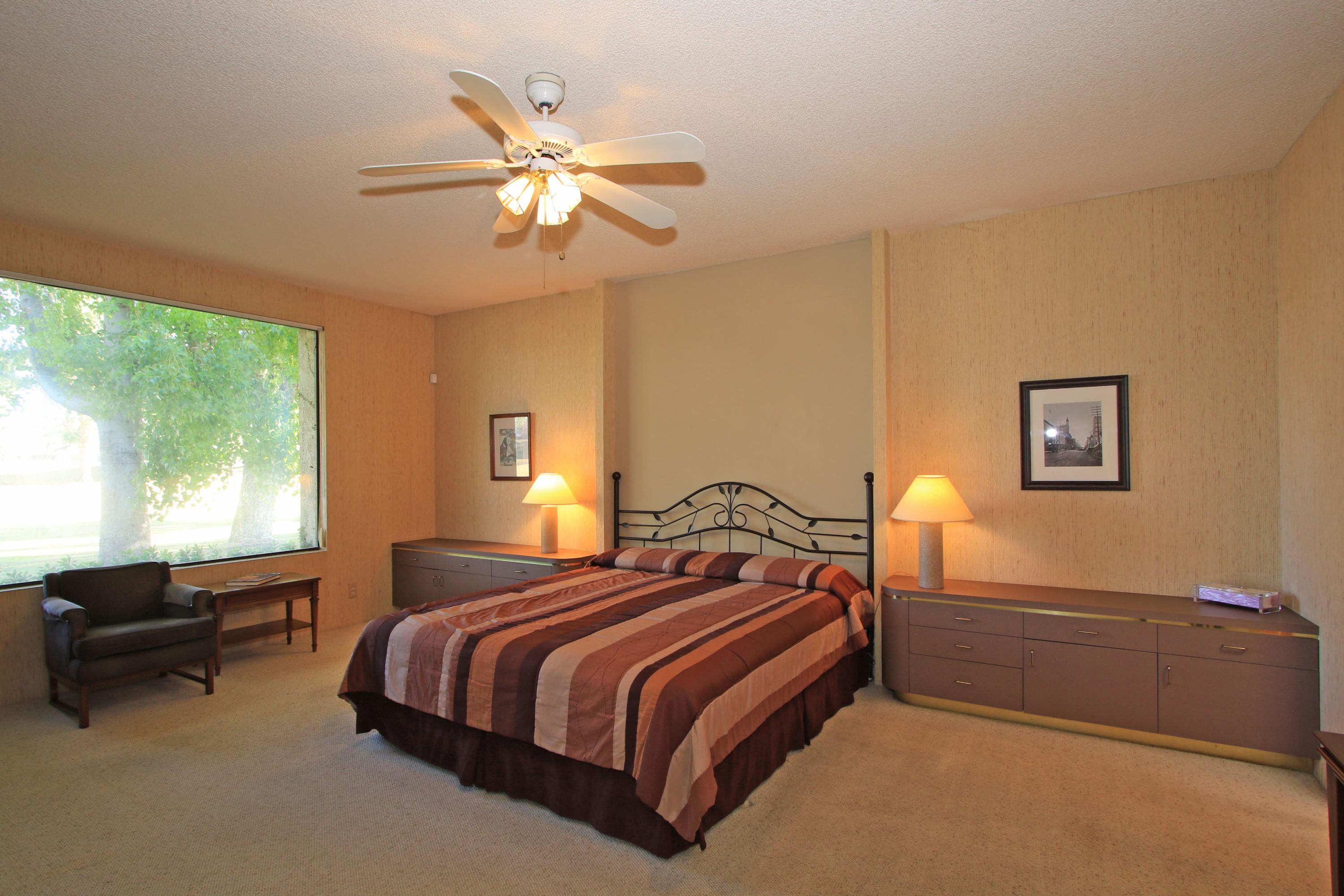 924 Inverness Drive Rancho Mirage, CA 92270 - Photo 20 of 44 a bedroom with a bed and a chandelier