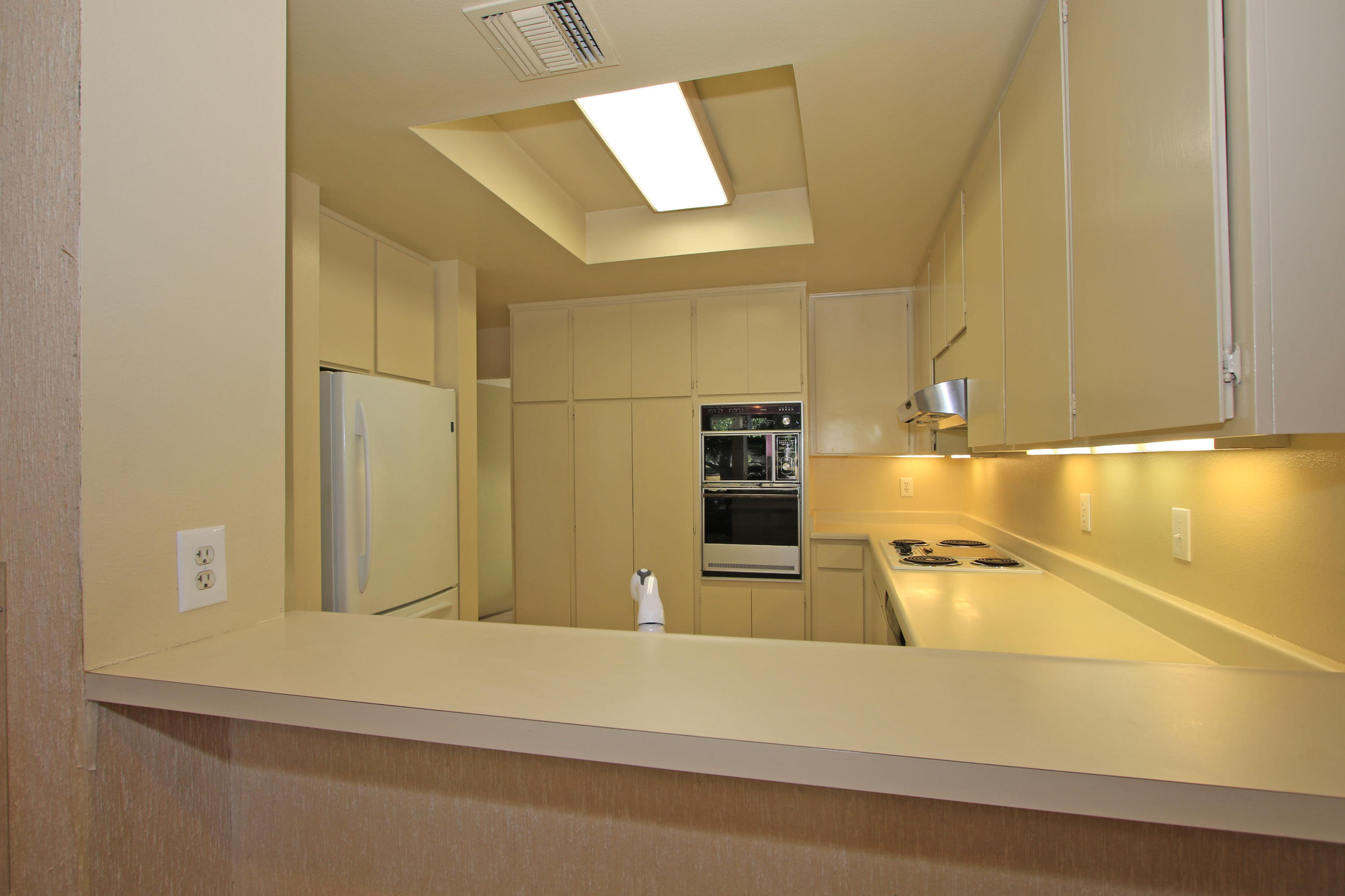 924 Inverness Drive Rancho Mirage, CA 92270 - Photo 28 of 44 a view of a kitchen with a sink and a refrigerator