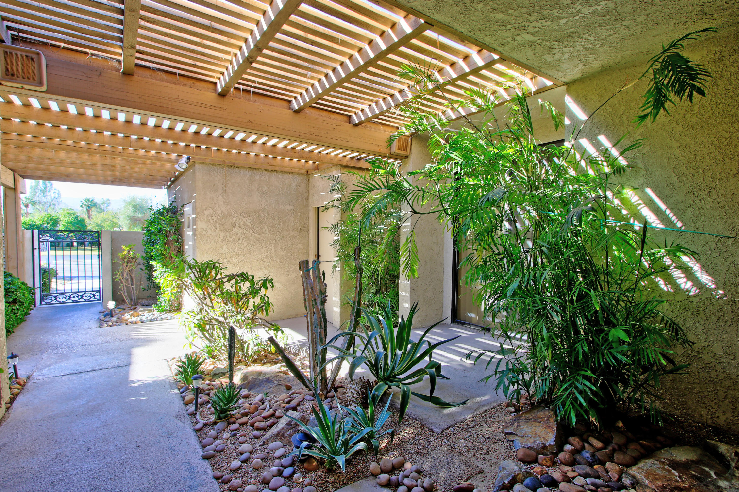 924 Inverness Drive Rancho Mirage, CA 92270 - Photo 3 of 44 a house with potted plants in front of it