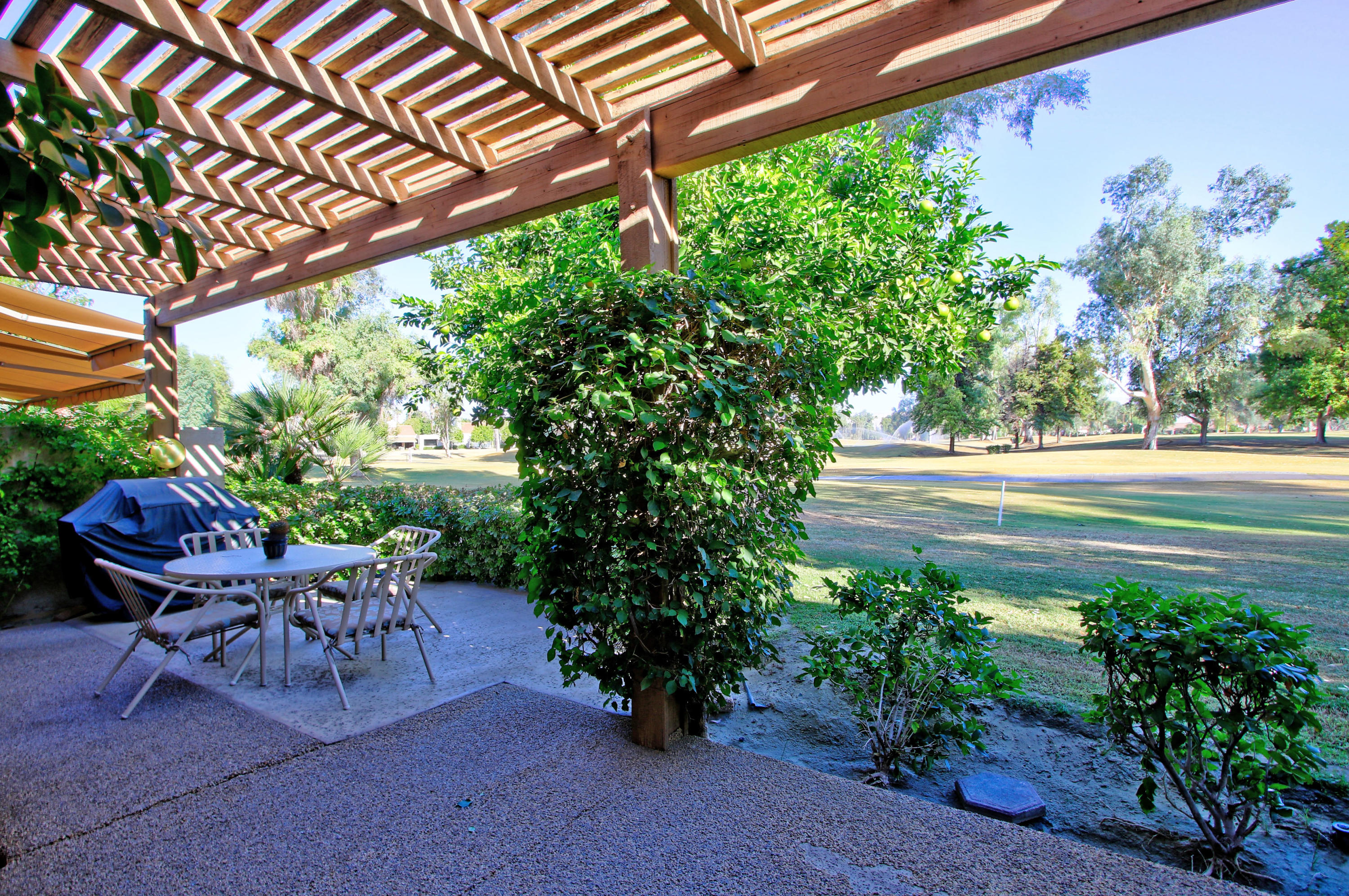 924 Inverness Drive Rancho Mirage, CA 92270 - Photo 33 of 44 a view of a chairs and table in a garden