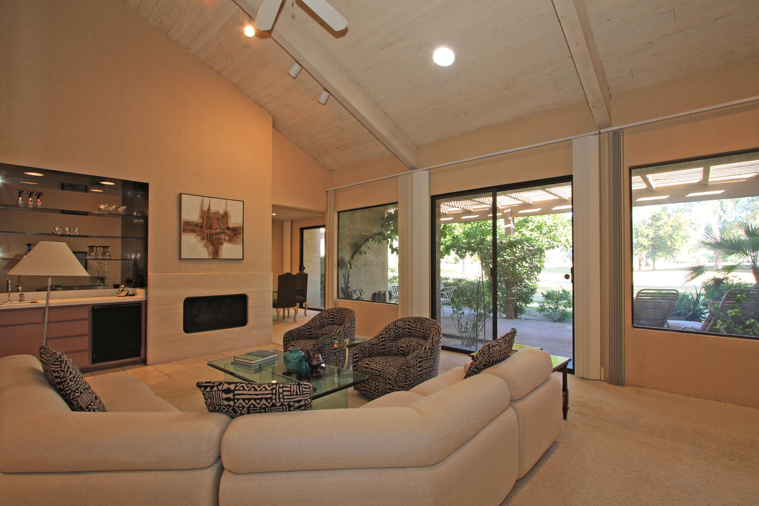 924 Inverness Drive Rancho Mirage, CA 92270 - Photo 4 of 44 a living room with furniture large window and fireplace