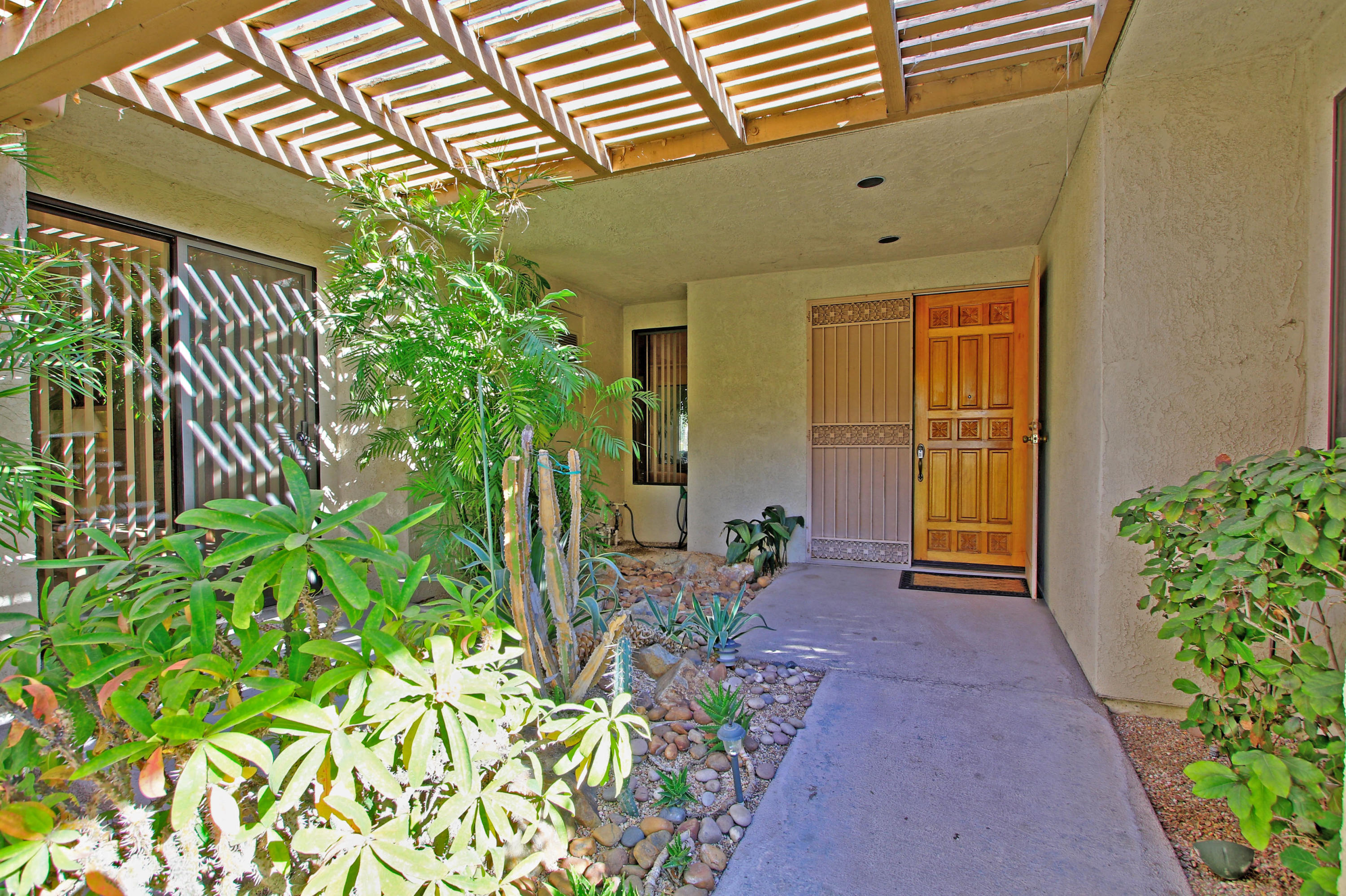 924 Inverness Drive Rancho Mirage, CA 92270 - Photo 10 of 44 front view of a house with a yard