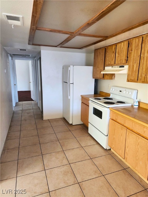 2308 Seco Adobe Circle North Las Vegas, NV 89030 - Photo 4 of 11 Kitchen with white appliances, light tile patterned floors, light countertops, and under cabinet range hood