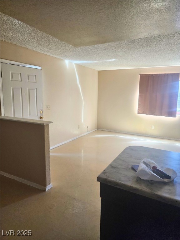 2308 Seco Adobe Circle North Las Vegas, NV 89030 - Photo 5 of 11 Unfurnished room with a textured ceiling and finished concrete flooring