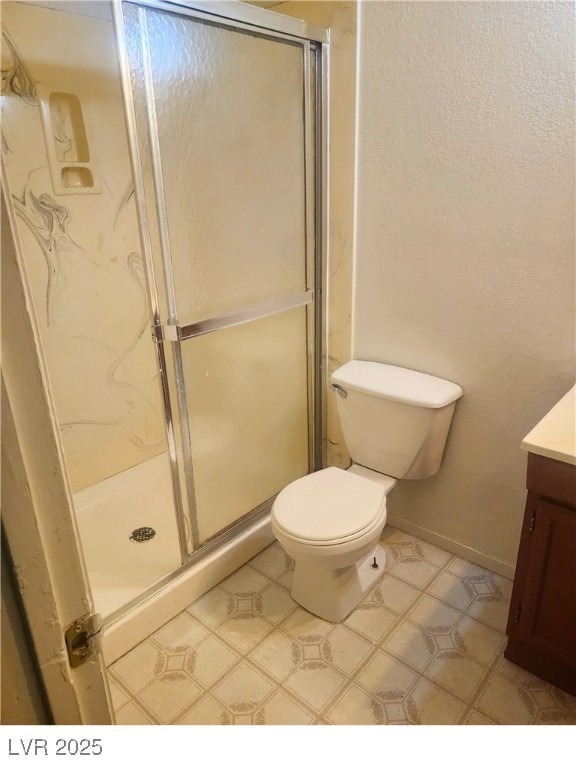 2308 Seco Adobe Circle North Las Vegas, NV 89030 - Photo 9 of 11 Bathroom with vanity, a textured wall, and a shower stall