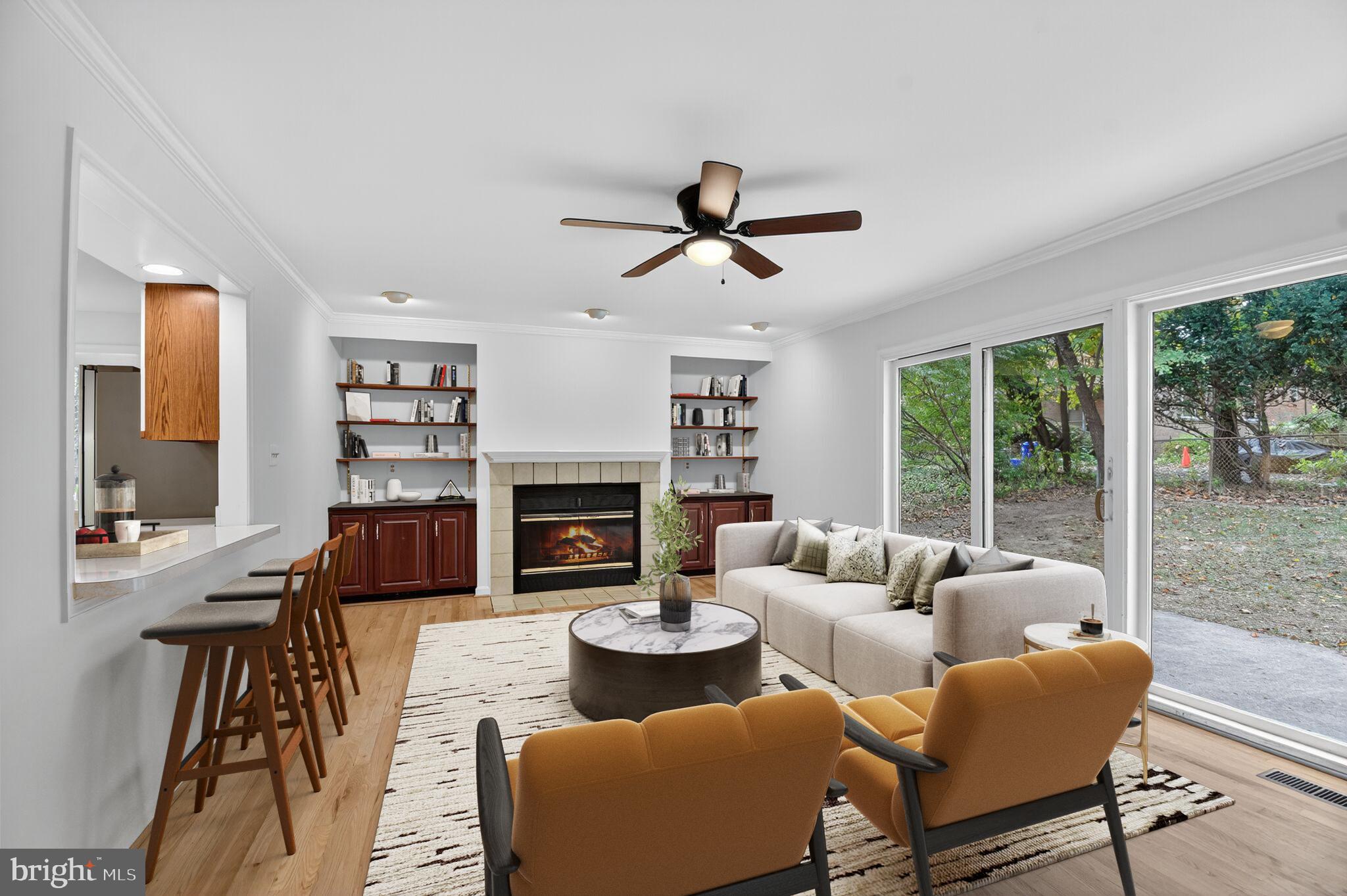 11902 Bernard Drive Silver Spring, MD 20902 - Photo 14 of 47 a living room with furniture a fireplace and a large window