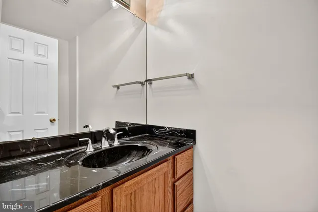 a view of a sink and dishwasher with wooden floor